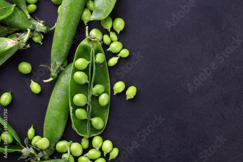 Fresh green peas on a black background