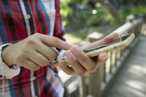 Women look at the smart phone in the park