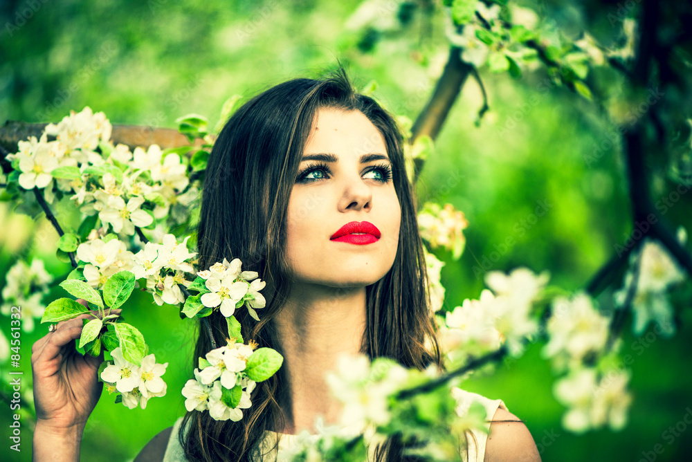 One pretty girl in the garden under the blossom tree One pretty girl in the garden under the blossom tree