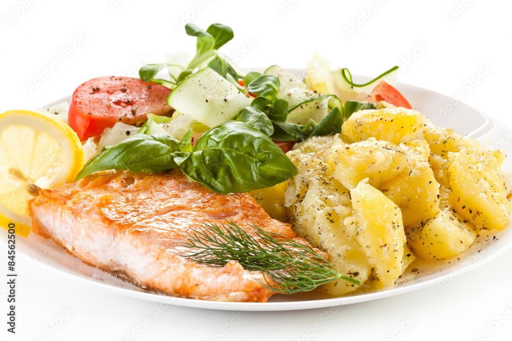 Fried salmon and vegetables on white background Fried salmon and vegetables on white background