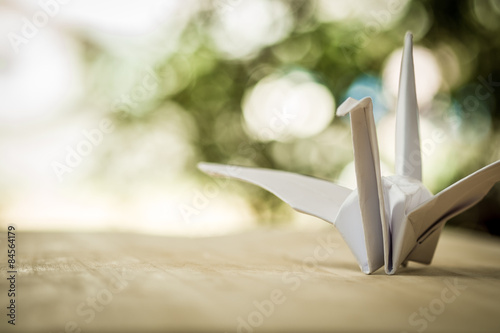 Origami crane, paper bird and bokeh background. shallow deep of