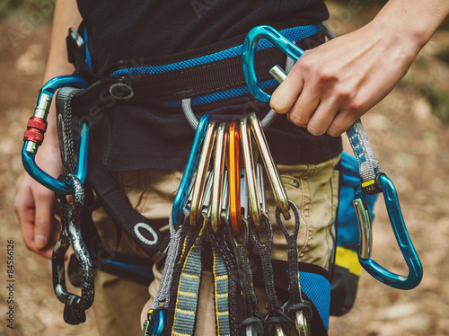 Female rock climber wearing safety harness