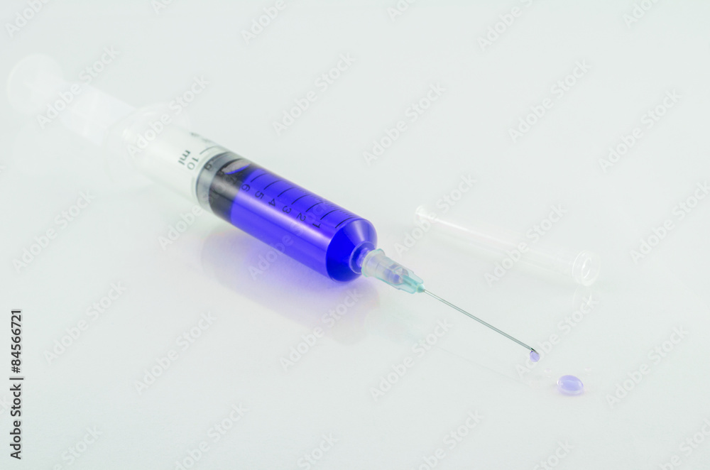 Medical syringe with drop on white background Medical syringe with drop on white background