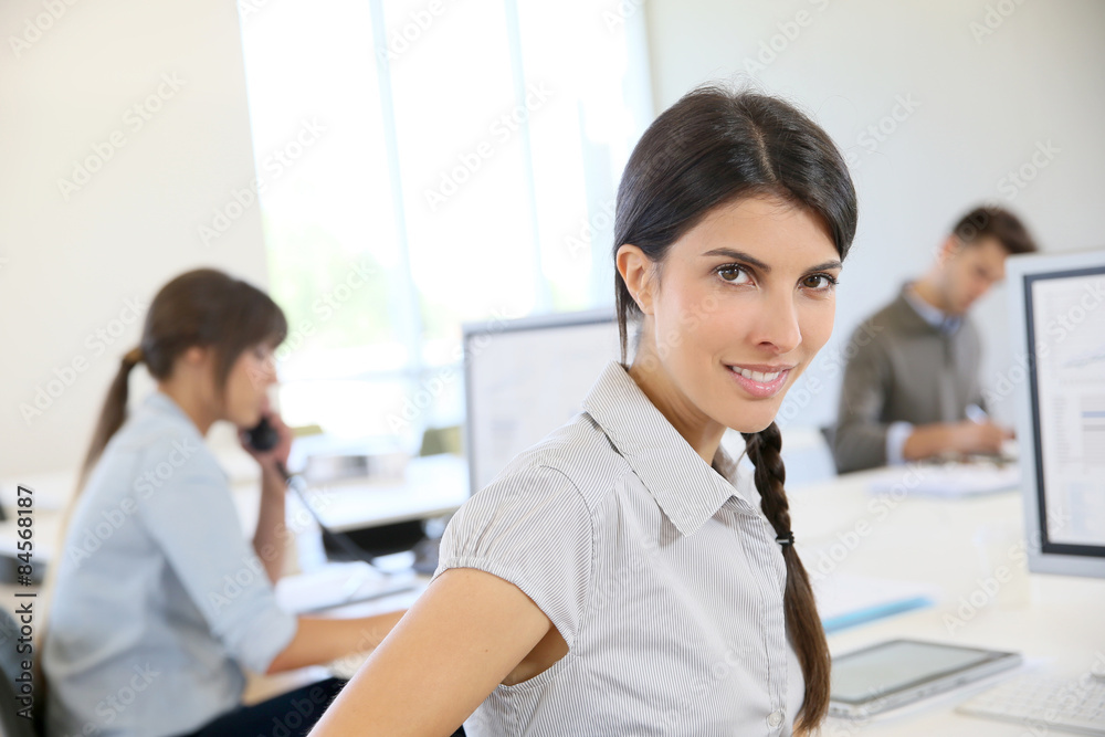 Portrait of young brunette woman working in office Portrait of young brunette woman working in office