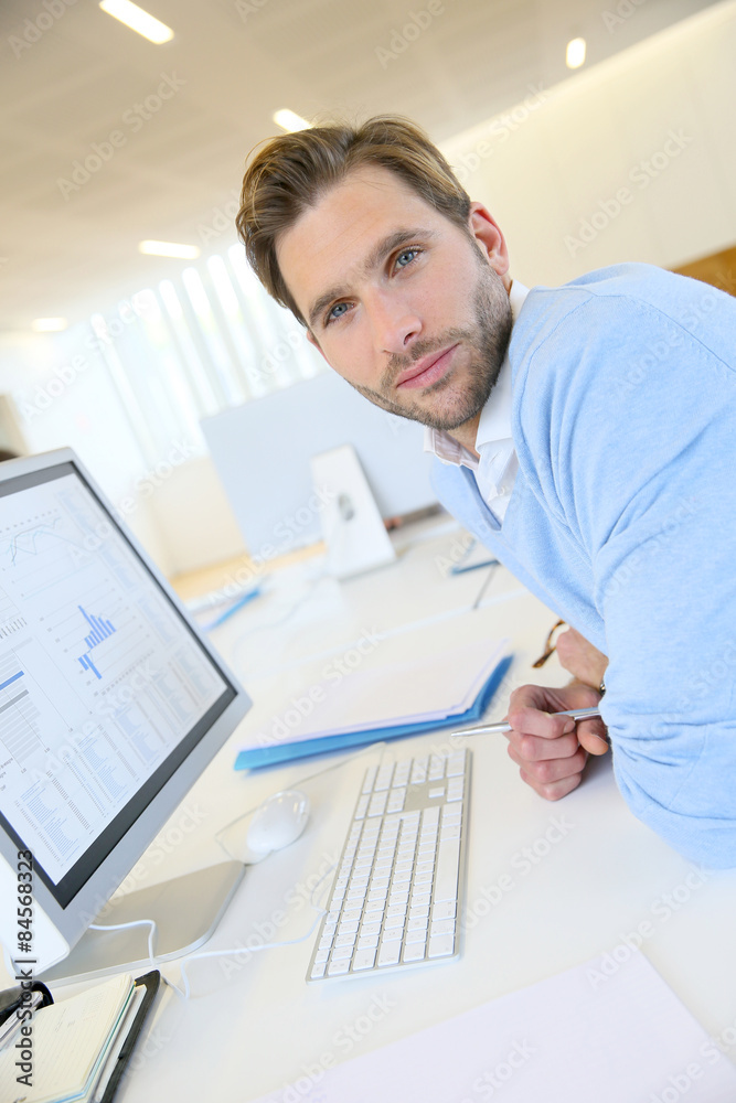 Portrait of businessman working on desktop computer Portrait of businessman working on desktop computer