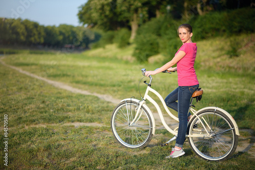 young girl on a bicycle on the river