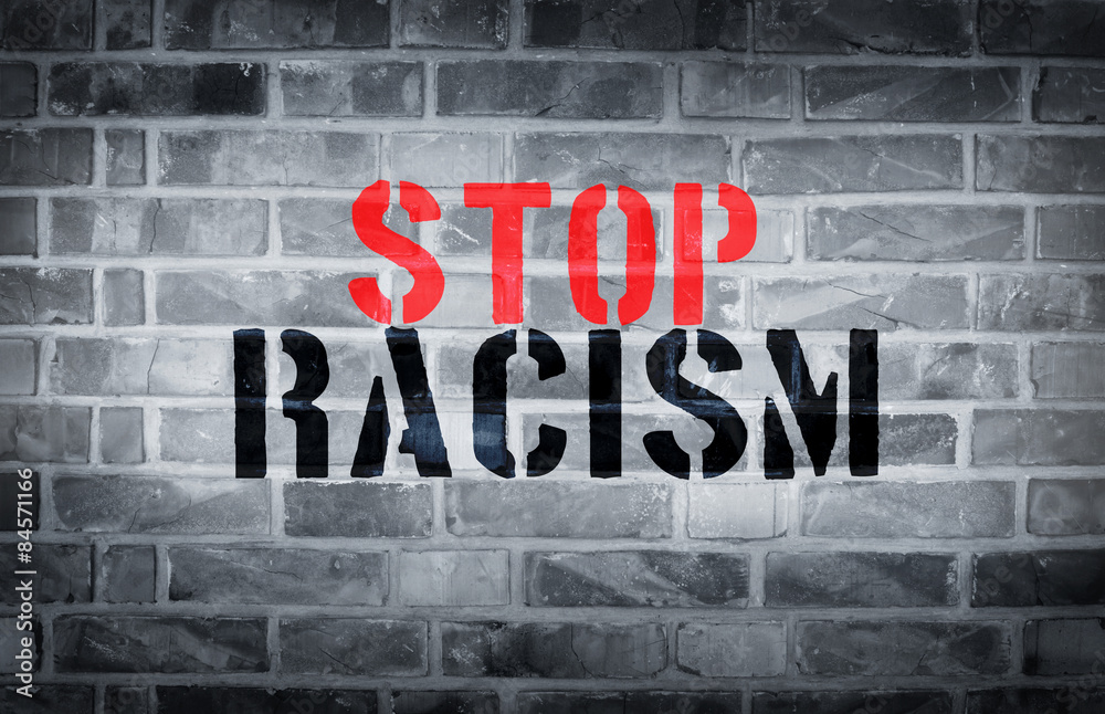 Stop racism stencil print on white wall background