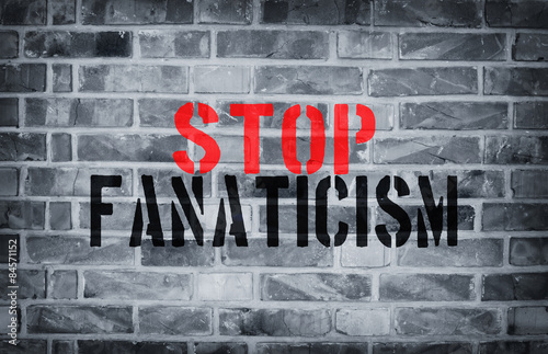 Foto Stop Fanaticism stencil print on the grunge white brick wall