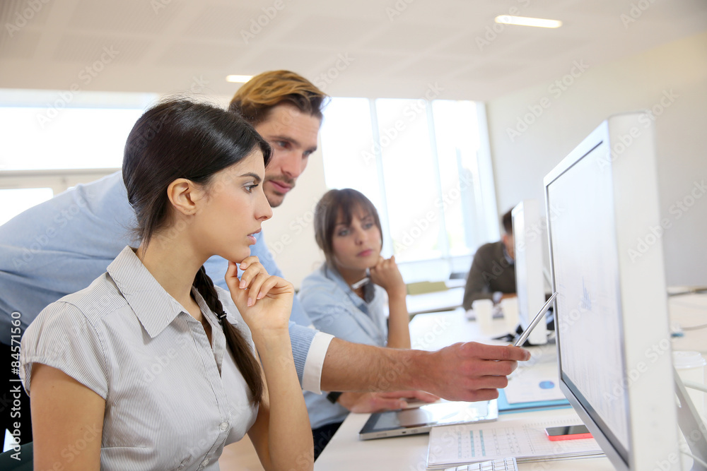 Business people working in office on desktop computer Business people working in office on desktop computer