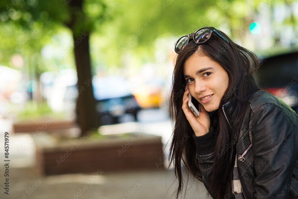 Young beautiful woman talking at the phone. New York City. Young beautiful woman talking at the phone. New York City.