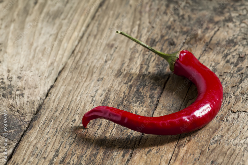 Red hot chili peppers on old wooden table, selective focus Red hot chili peppers on old wooden table, selective focus