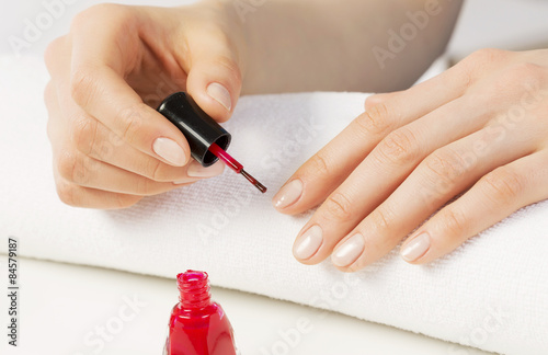 Woman applying polish