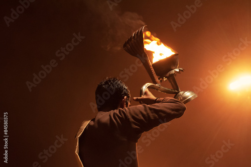 Foto Indian priest performs religious Ganga Aarti ceremony or fire puja at Dashashwamedh Ghat in Varanasi