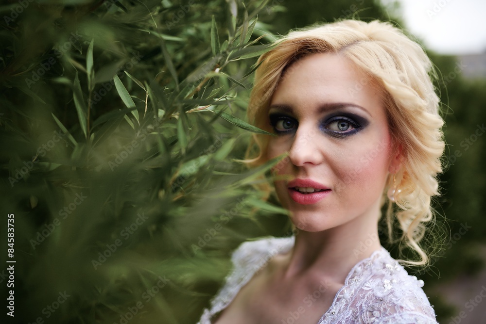 Portrait beautiful young bride in white dress in summer green park Portrait beautiful young bride in white dress in summer green park