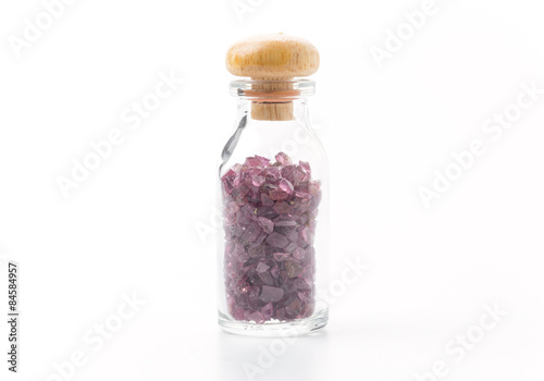 rhodolite in glass bottle isolated on white background photo