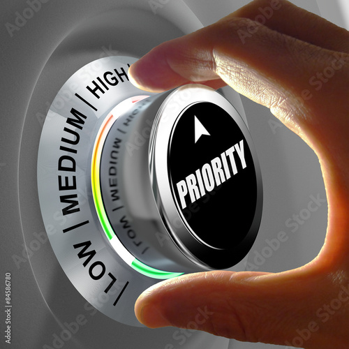 Hand rotating a button and selecting the level of priority.