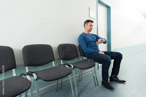 Man Checking Time In Hospital