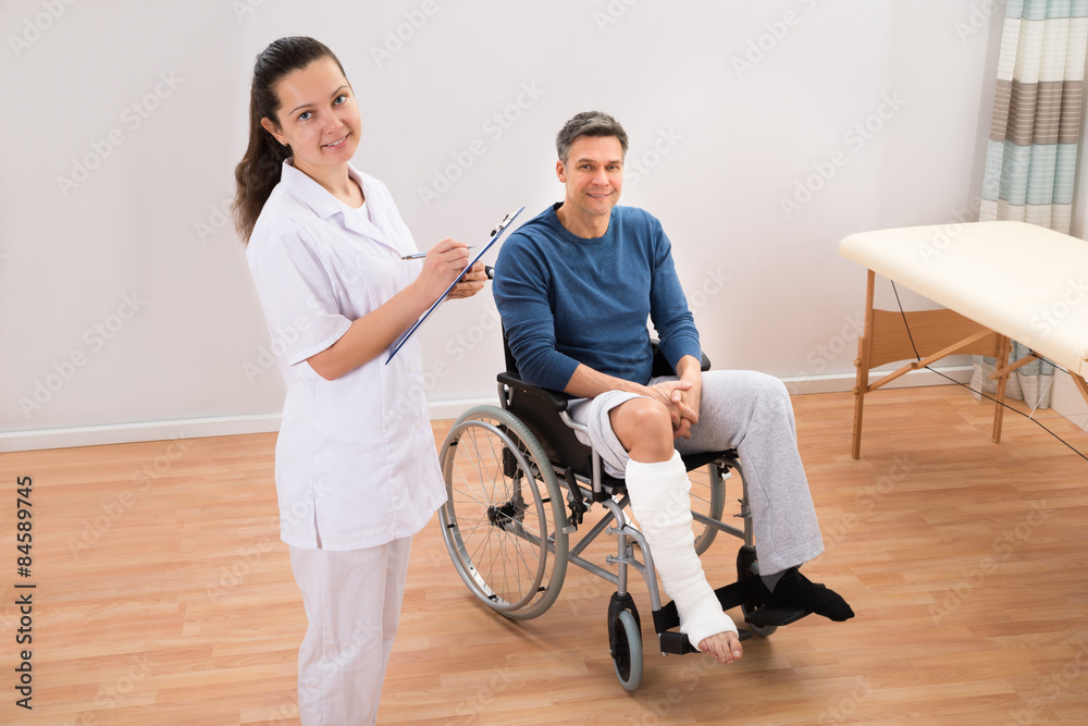 Doctor With Patient Writing On Clipboard Doctor With Patient Writing On Clipboard