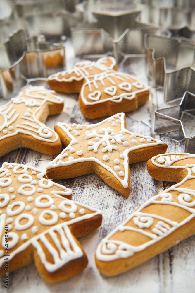 Christmas gingerbread cookies and metal cookie cutters on white