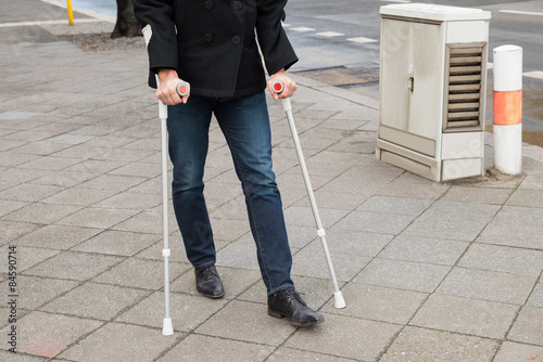 Man Trying To Walk Using Crutches