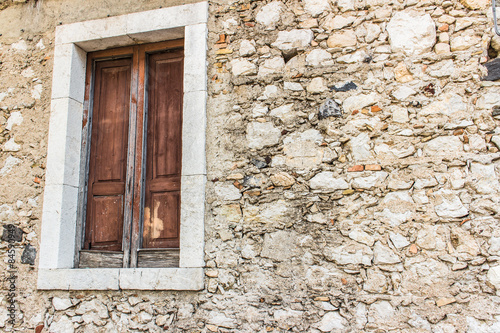 old window and rocky wall