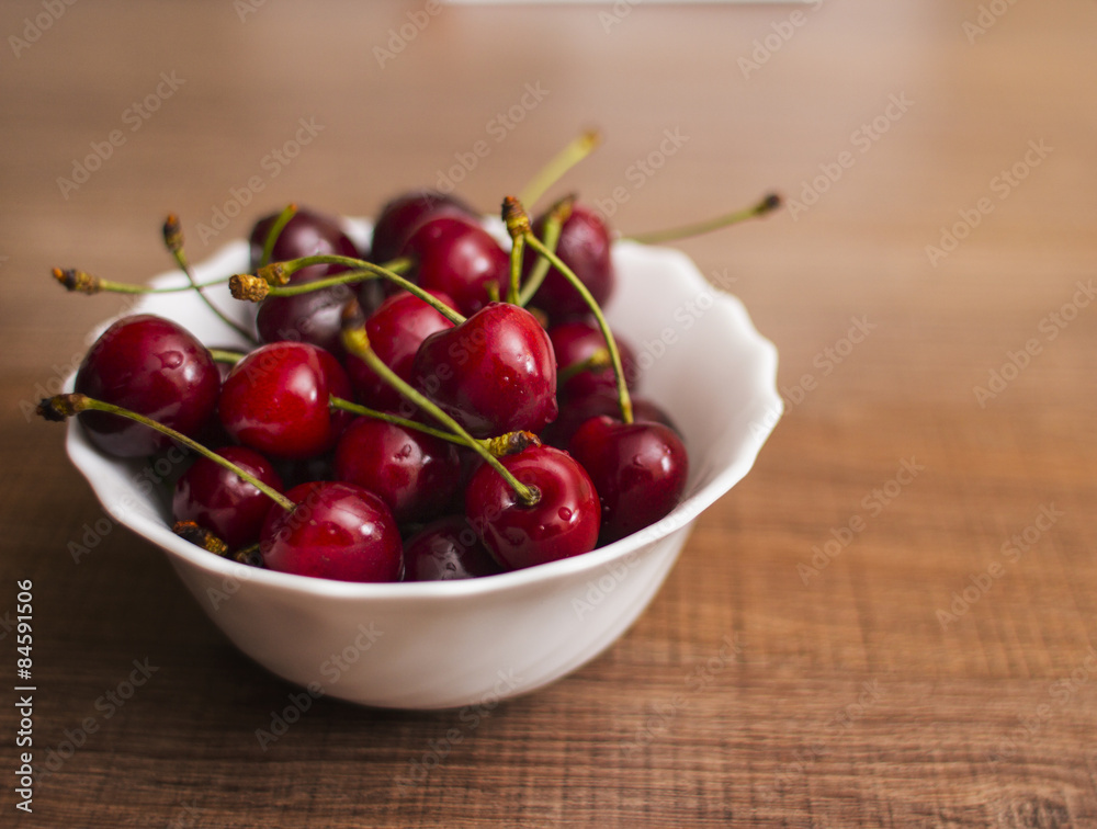 Cherries on wooden table with water drops macro background Cherries on wooden table with water drops macro background