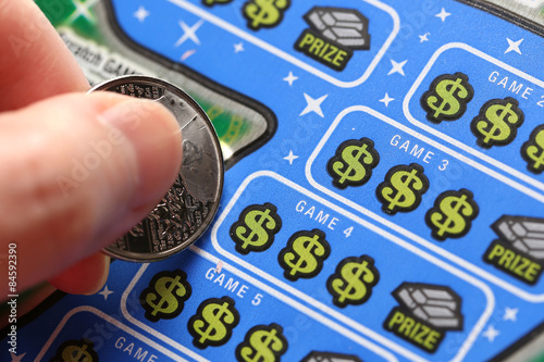 Close up woman scratching lottery tickets