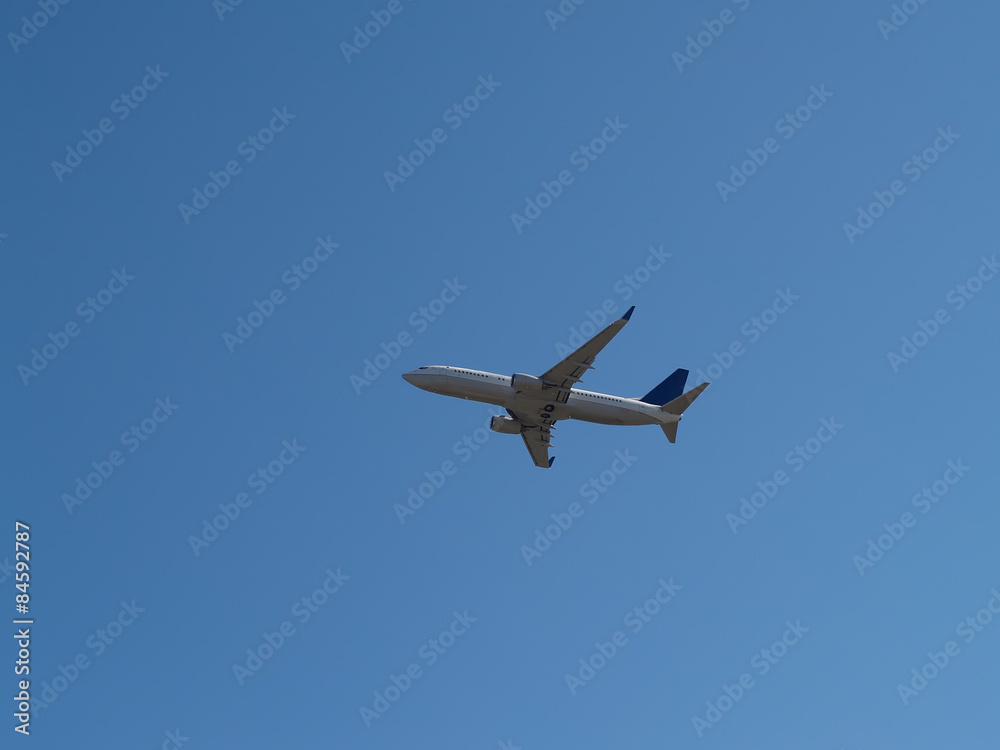 Commercial Jet Liner Climbing Into Blue Sky