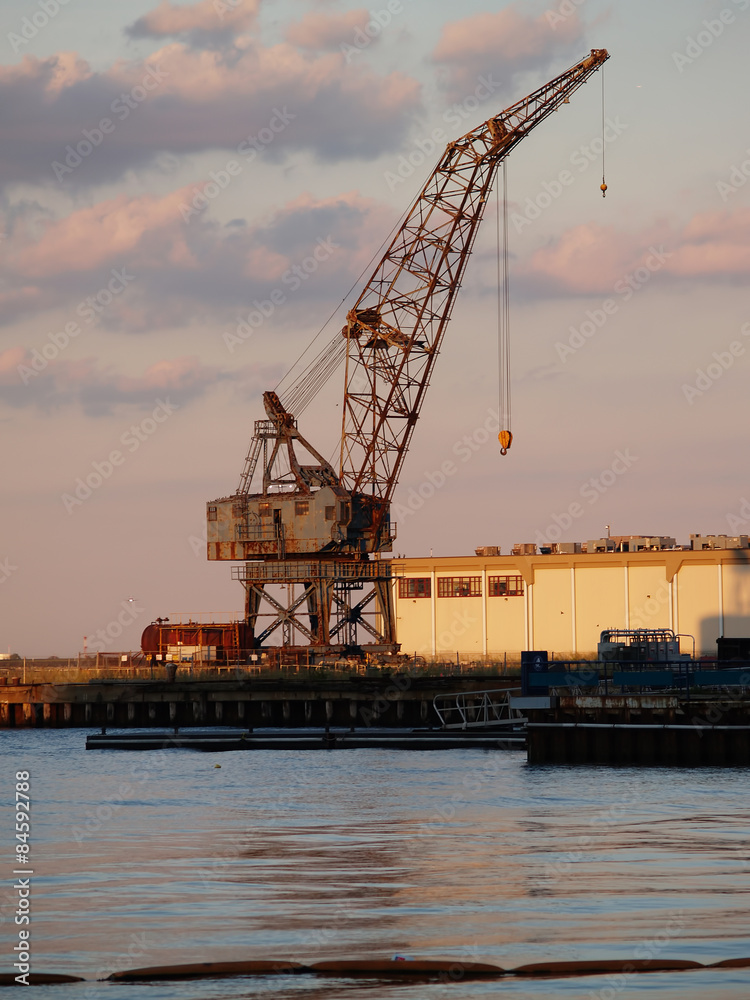 Rusted Grey Crane Harbor Against Cloudy Sky