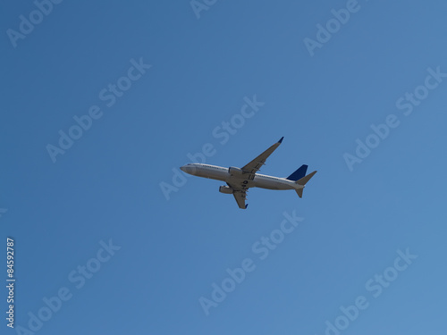 Commercial Jet Liner Climbing Into Blue Sky