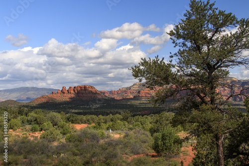 A couple hiking in the distance and enjoying the sunrise near Cockscomb Butte in Sedona Arizona
