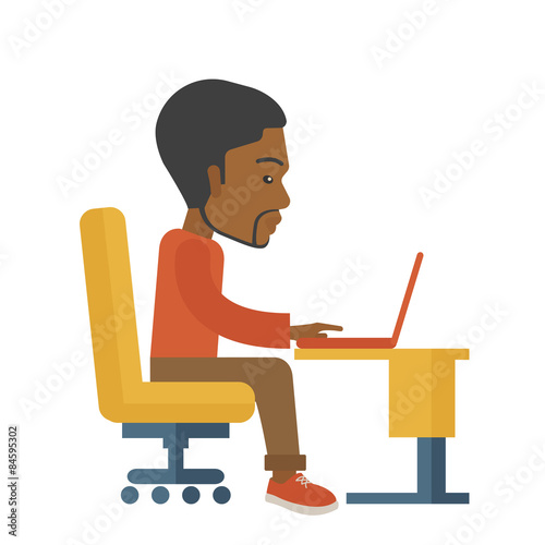 African sitting infront his computer.