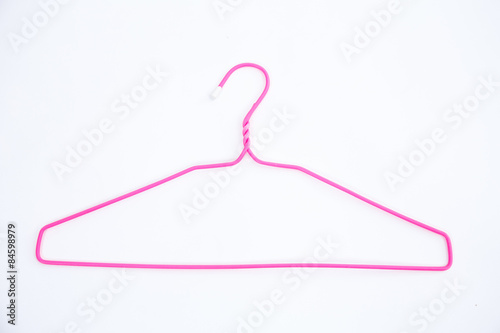 Pink wire hangers on white background