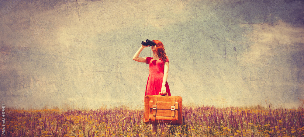 Fototapeta girl in red dress with suitcase and binocular