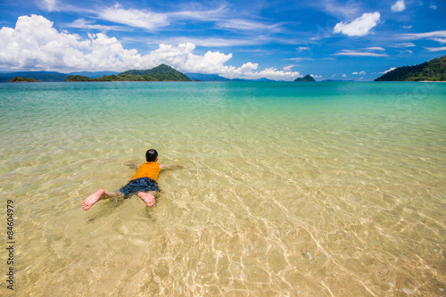 Fototapeta Naklejka Na Ścianę i Meble -  man is swimming sea in sea and blue sky at Ranong, Thailand