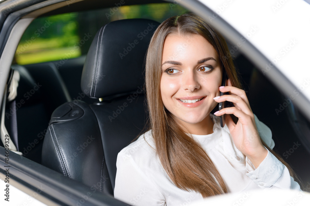 Woman using mobile phone in car 