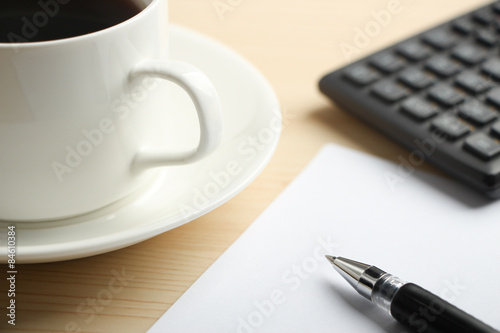 White paper calculator and coffee