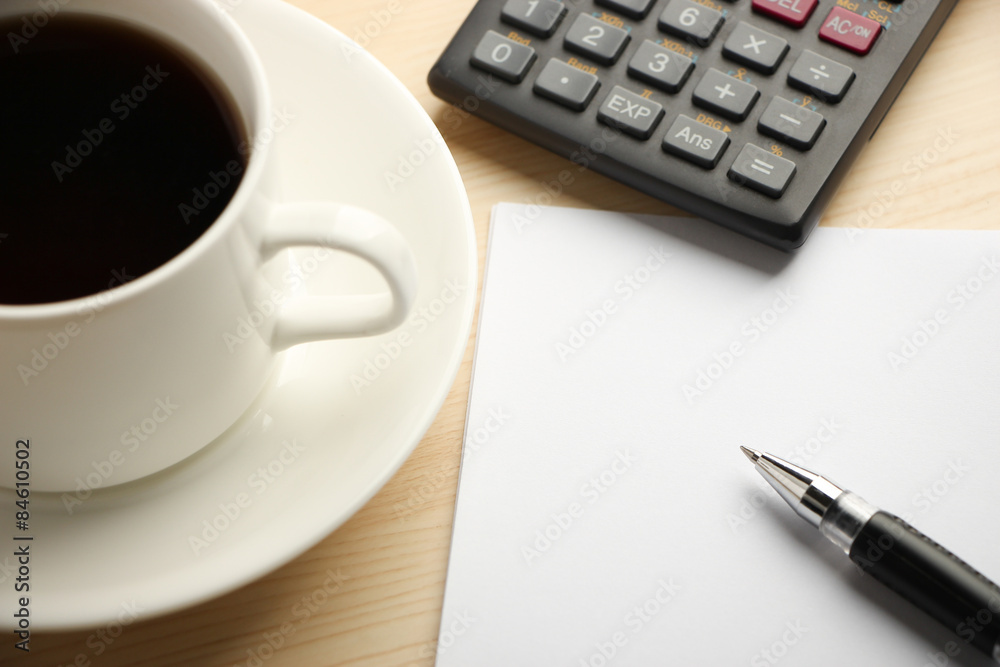 White paper calculator and coffee White paper calculator and coffee