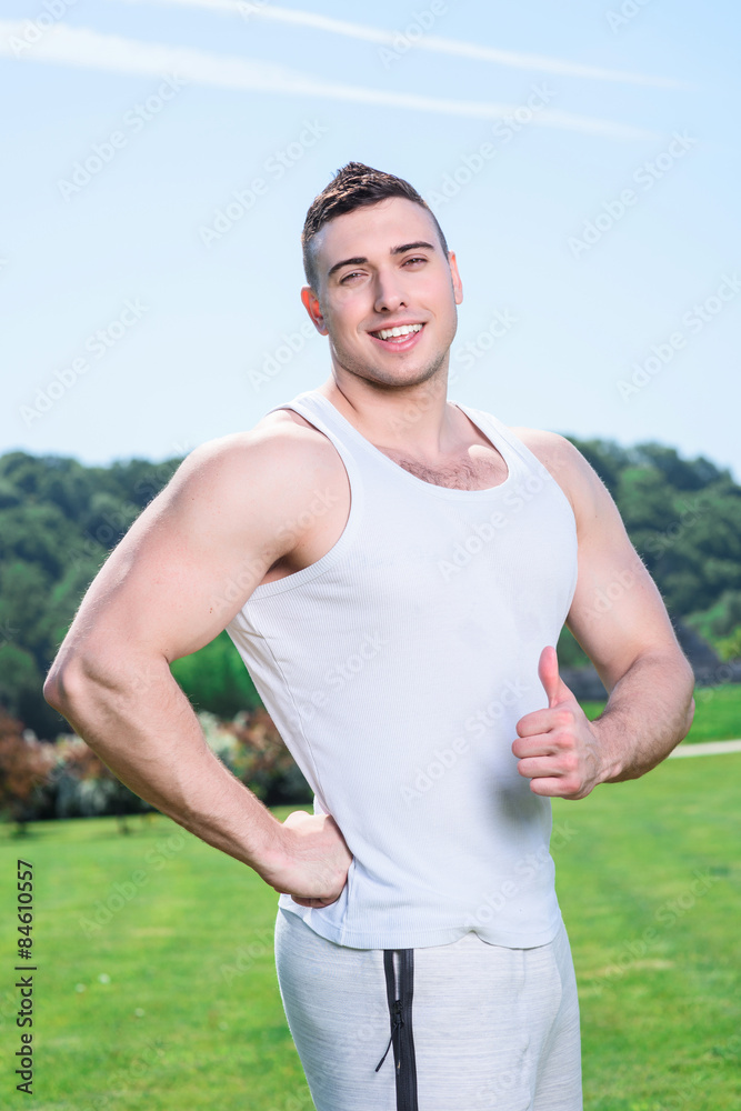 Handsome sportsman doing exercises outdoors