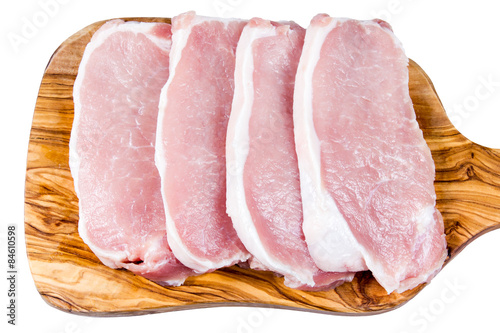 Boneless Pork Loin Steaks on cutting board. Isolated on white background