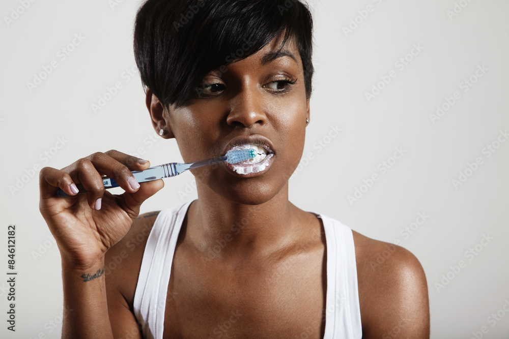 woman is cleaning her teeth and bothering