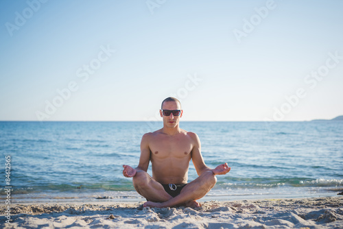 young handsome sporty man making yoga