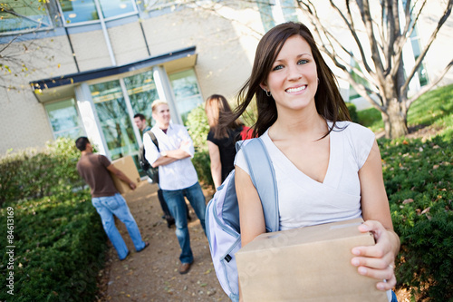 фотографія College: Girl Moving Into Dorm with Box