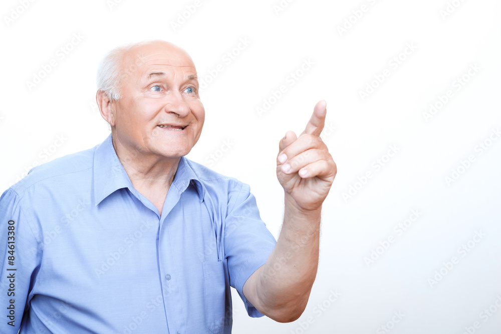 Inspired grandfather pointing with index finger Inspired grandfather pointing with index finger