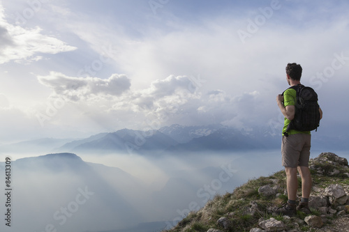 Hiker standing and enjoying incredible view of mountains
