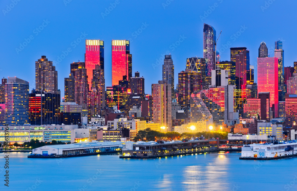 Fototapeta premium Manhattan skyline with red sunlight reflection.