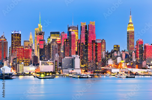Manhattan skyline with red sunlight reflection.