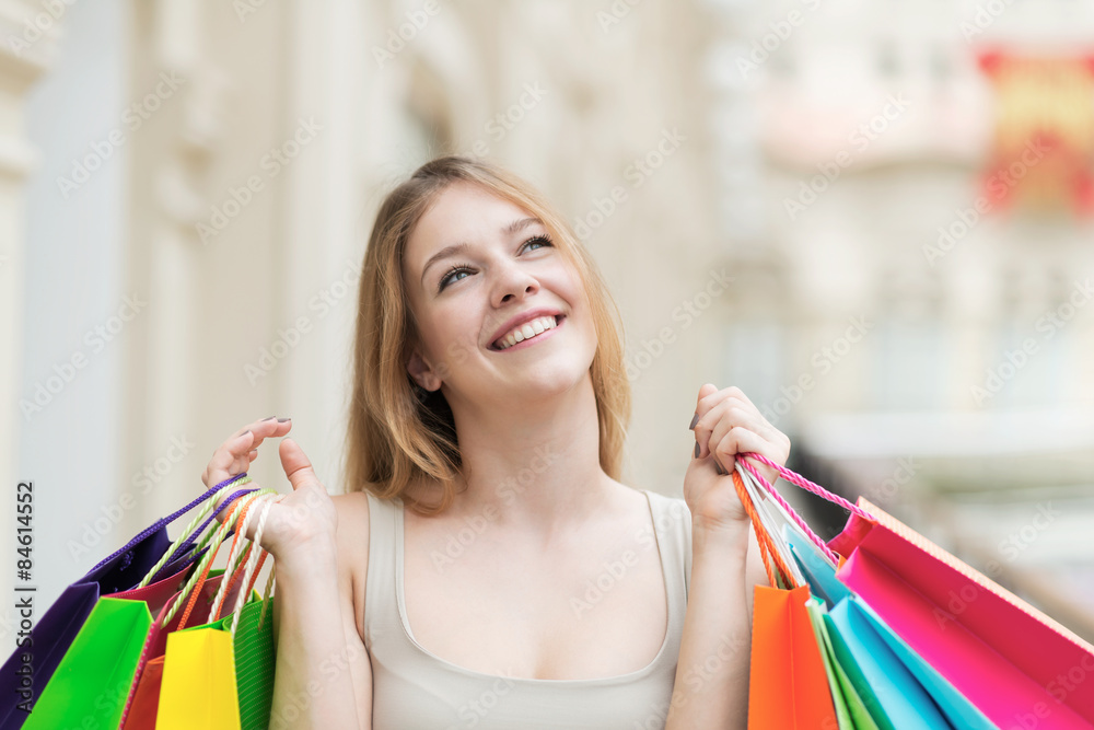 A happy young girl with the colourful shopping bags from the fancy shops. A happy young girl with the colourful shopping bags from the fancy shops.