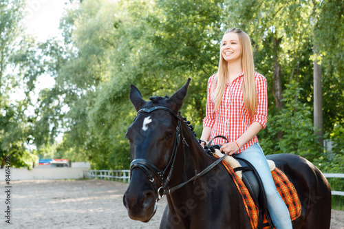 Upbeat girl riding the horse 