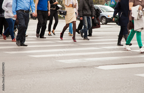 legs of pedestrians on a pedestrian crossing photo